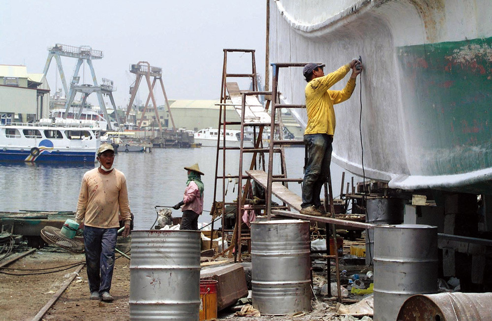 The Cijin island is known for having the most shipping companies in the nation. Workers overhaul ships.