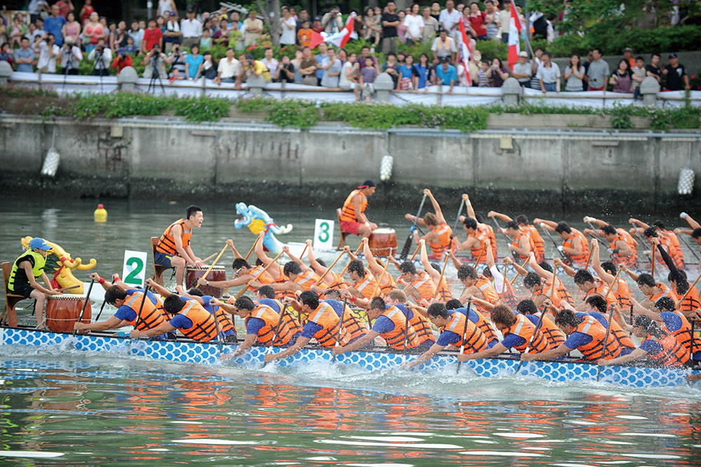 Teams paddle to the beat of a drum.