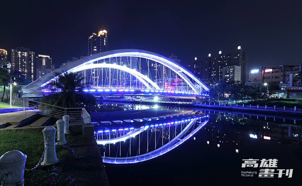 跨越愛河的願景橋位於中都濕地旁，夜晚打上藍色燈光，將河畔夜景點綴得浪漫夢幻。(攝影/Carter)